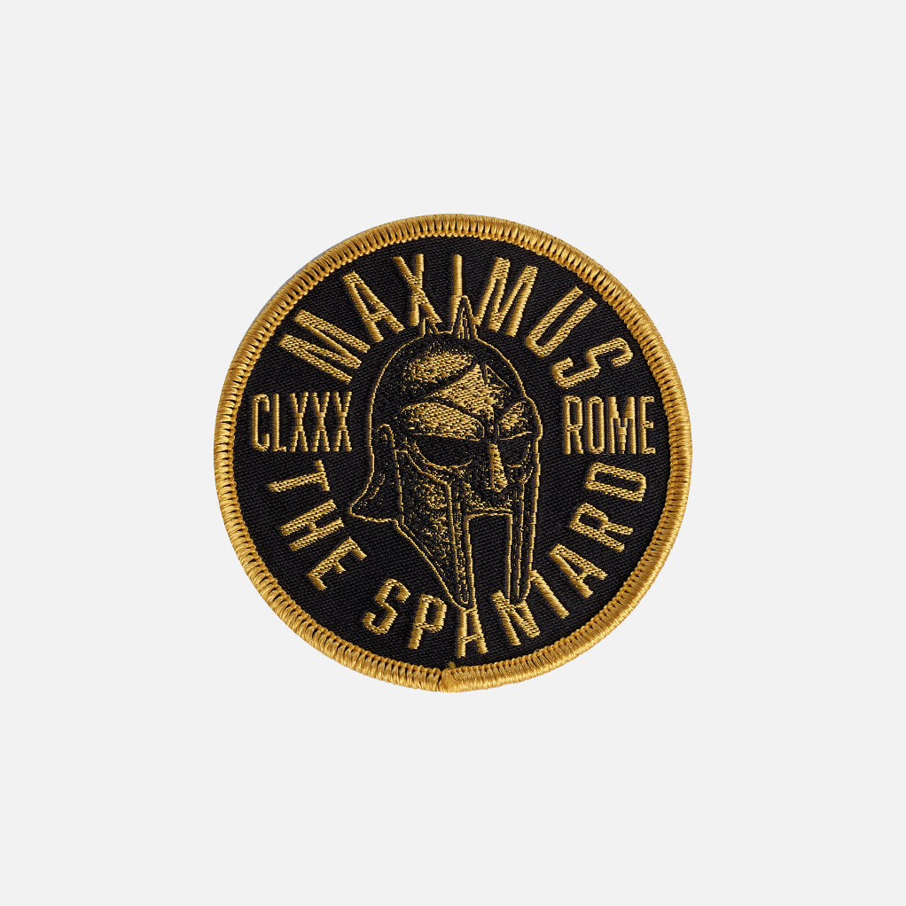 Circular patch with Roman helmet design and text on a white background